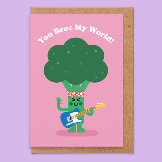 Love card with an illustration of a broccoli dressed as a rockstar playing a guitar and it says you broc my world!