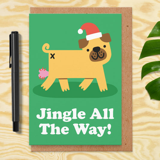 Christmas card with an illustration of a pug wearing a Santa hat and you can see its balls popping out. It reads jingle all the way!