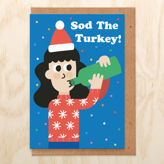 Christmas card with an illustration drinking from a bottle of wine and the text reads sod the turkey!