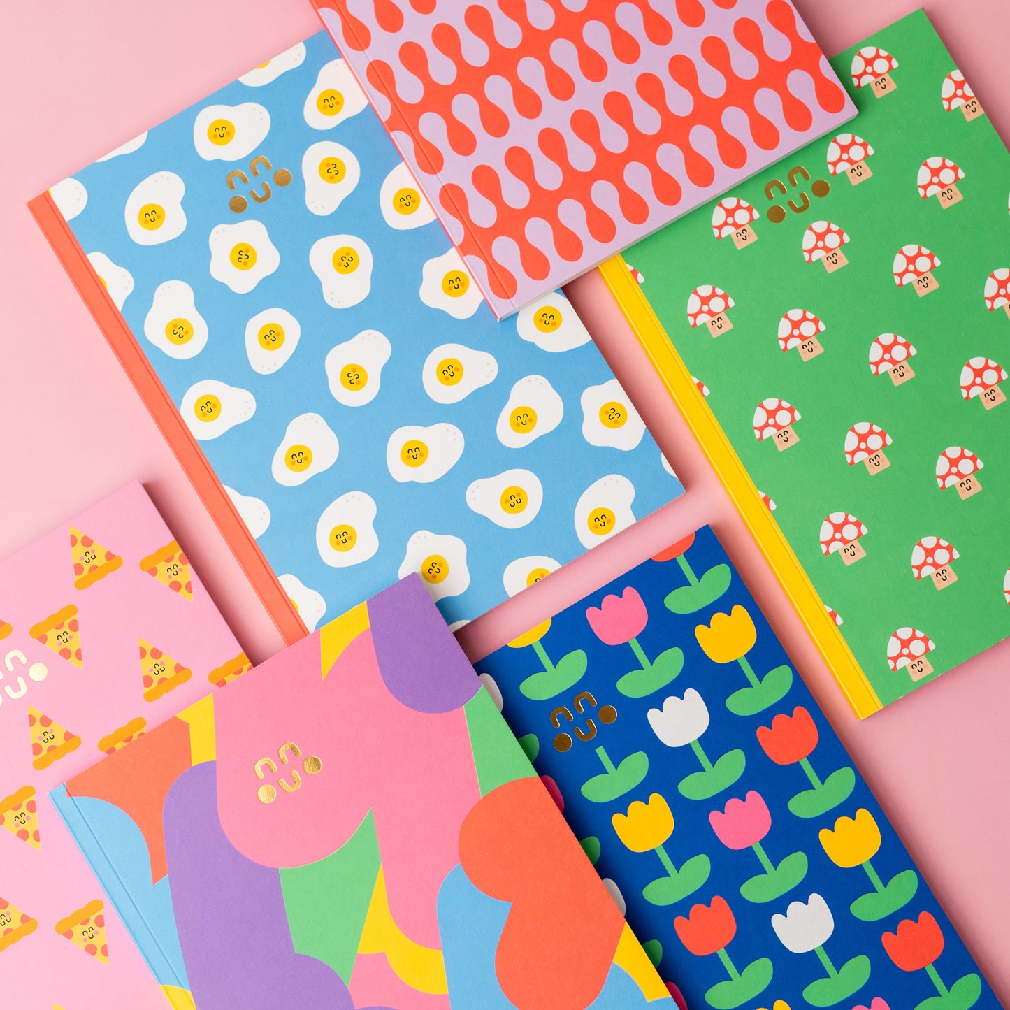 A collection of colourful notebooks with a variety of patterns