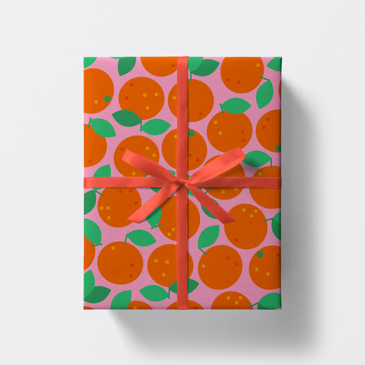 christmas present wrapped in clementine pattern wrapping paper by studio boketto