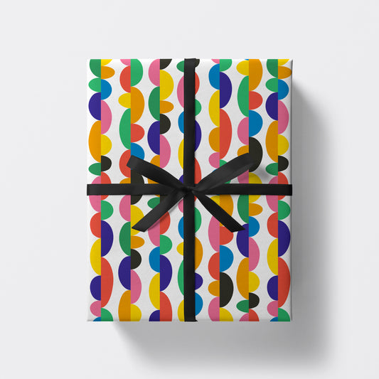 a square present wrapped in colourful pattern wrapping paper by studio boketto