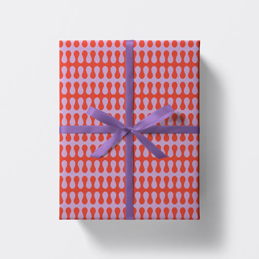 a square present wrapped in psychedelic pattern wrapping paper by studio boketto