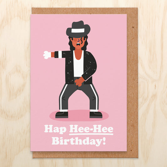 Birthday card featuring an illustration of MJ on a pink background and words saying hap her-hee birthday!
