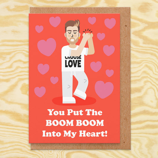 Love card with an illustration of the wham singer wearing a choose love t-shirt and the text reads you put the boom boom into my heart!
