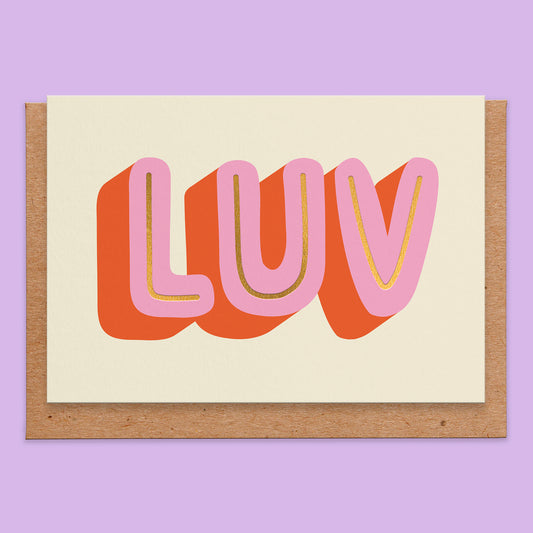 Love card with the letters luv in large in pink and red with some gold foil on a beige background.