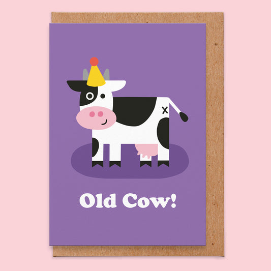 Birthday card with an illustration of a cow wearing a party hat on a purple background. The text reads old cow!