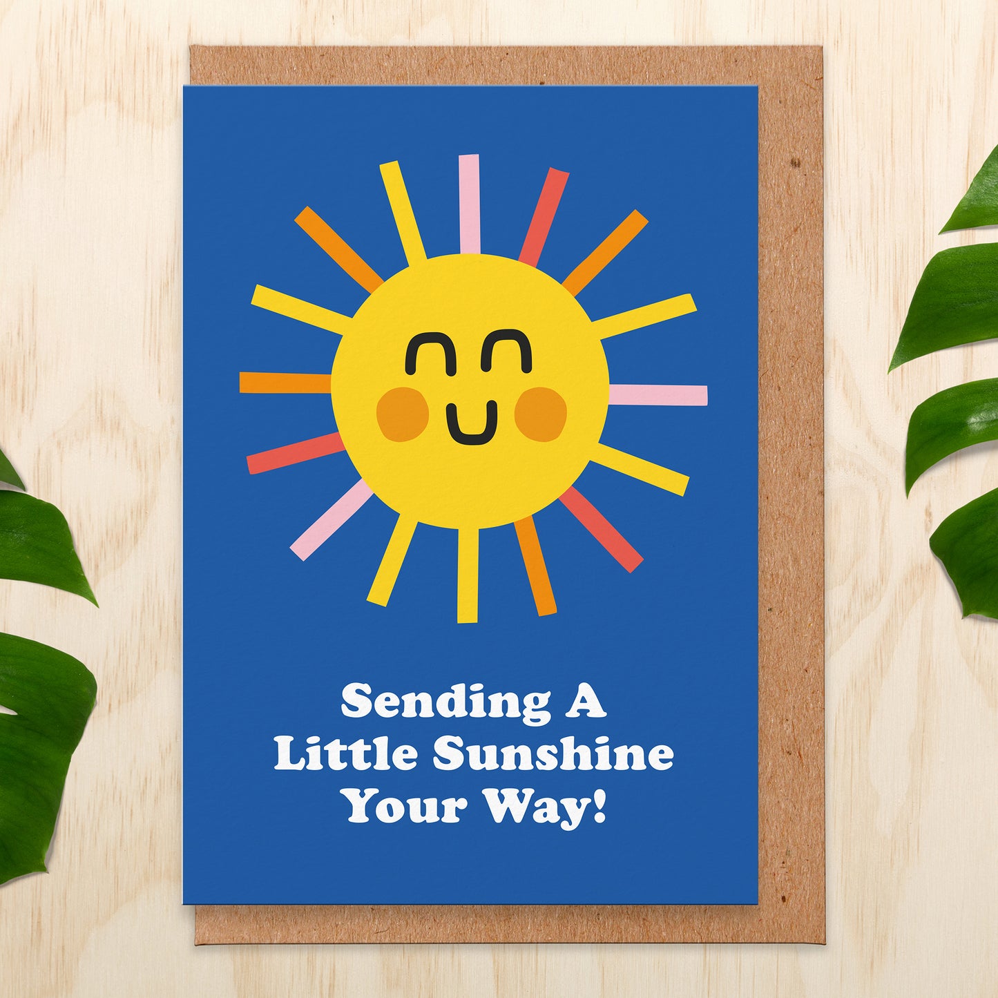 Greetings card with a sun on a blue background that reads Sending A Little Sunshine Your Way!