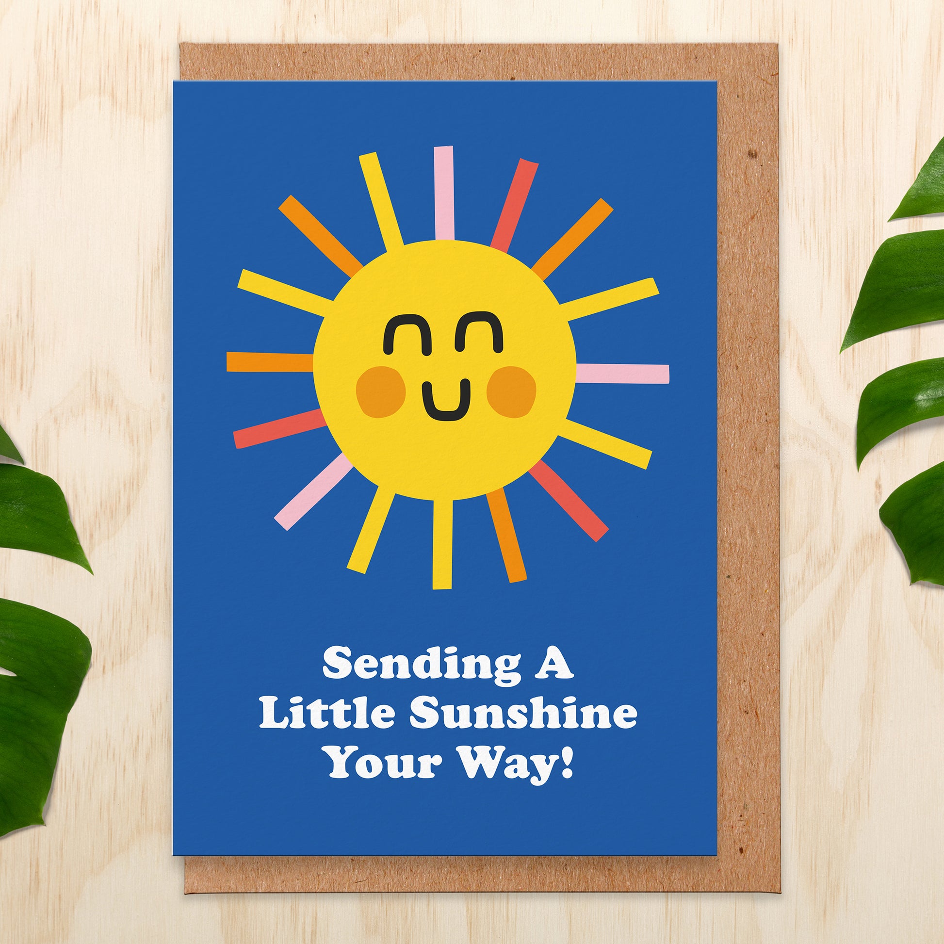 Greetings card with a sun on a blue background that reads Sending A Little Sunshine Your Way!