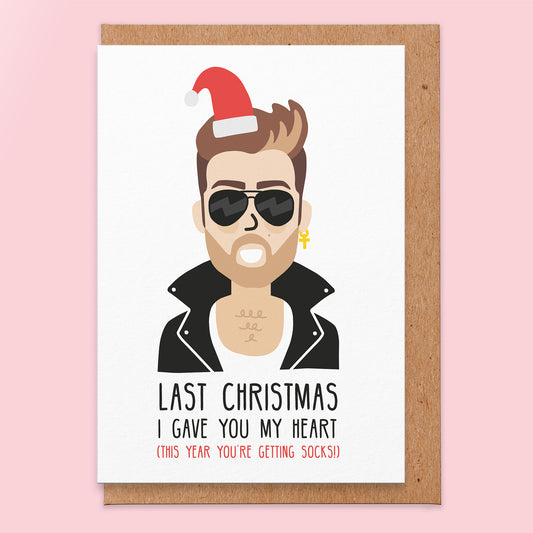 Christmas card with an illustration of the last christmas singer wearing a Santa hat and it reads last christmas I gave you my heart (this year you're getting socks!).