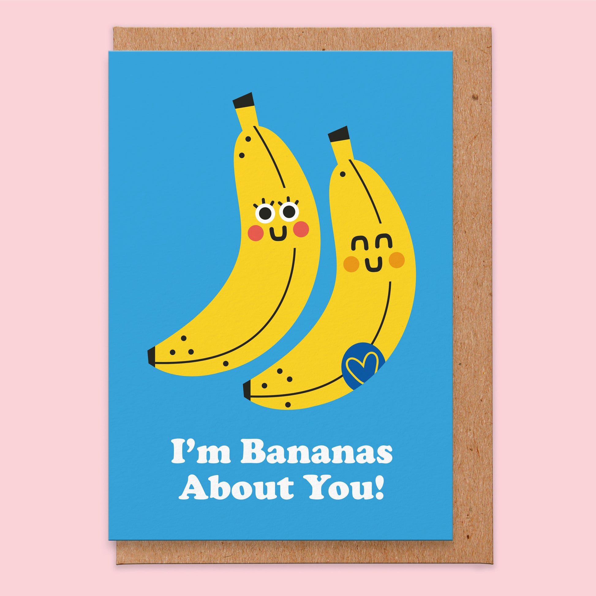 Love card that reads I'm bananas about you with  two smiling bananas on a bright blue background.