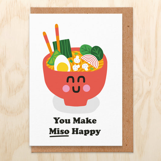 Greetings card with an illustration of a bowl of miso and chopsticks, the bowl has a smiley face and reads You Make Miso Happy