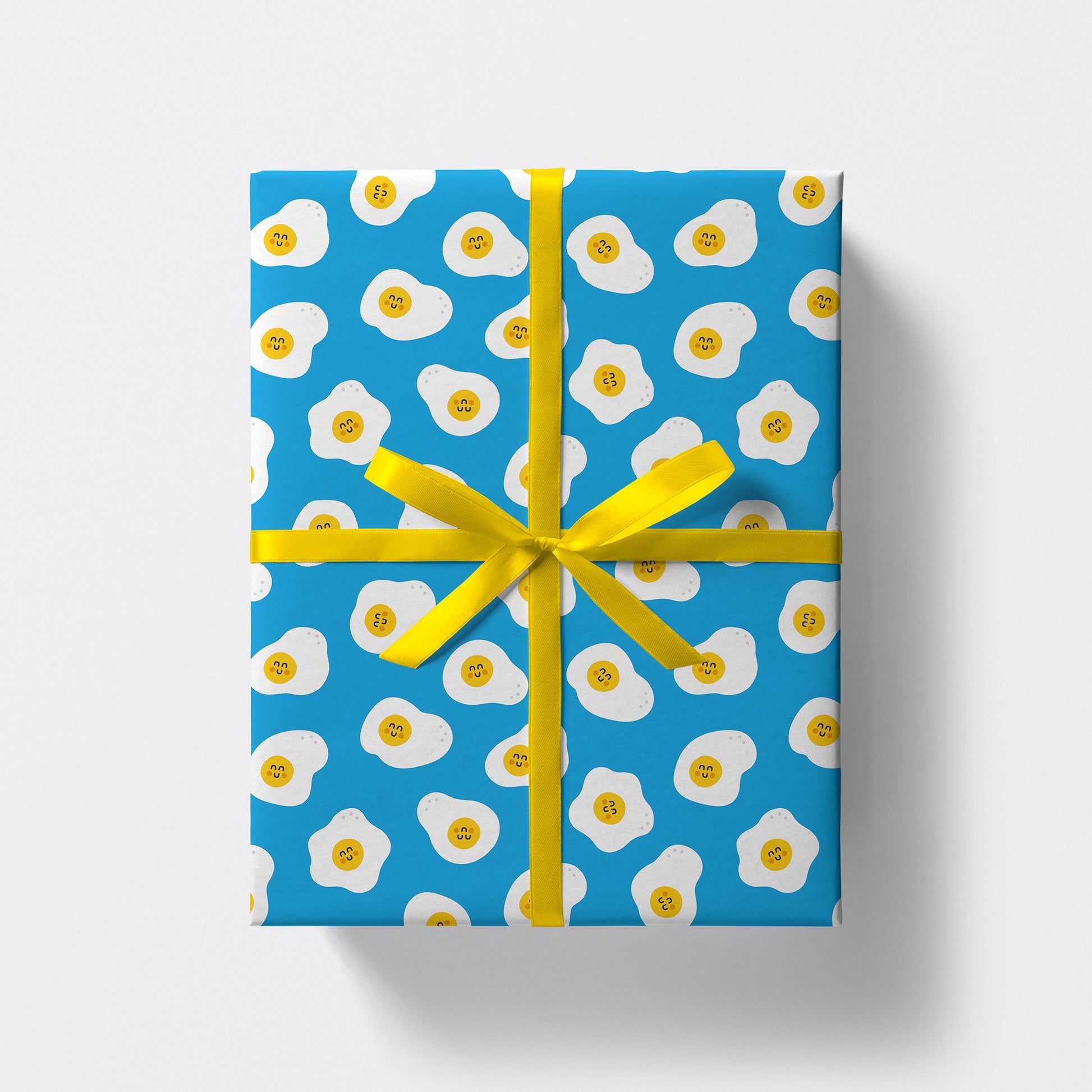 a square present wrapped in eggs pattern wrapping paper by studio boketto