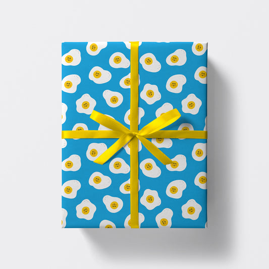 a square present wrapped in eggs pattern wrapping paper by studio boketto