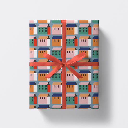 a square present wrapped in houses pattern wrapping paper by studio boketto