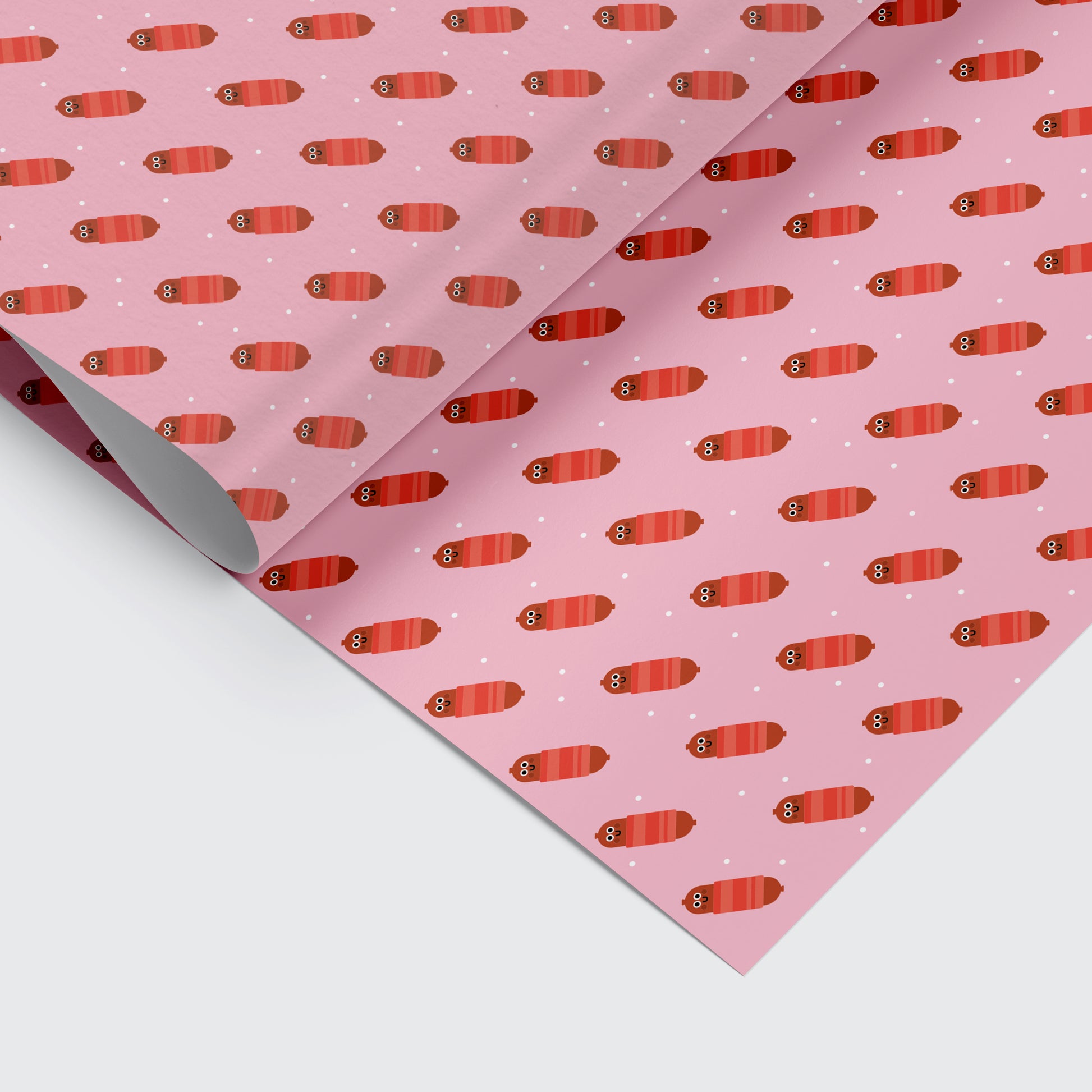 Christmas wrapping paper with pigs in blankets pattern on it
