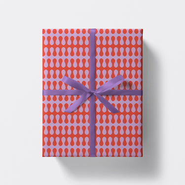 a square present wrapped in psychedelic pattern wrapping paper by studio boketto