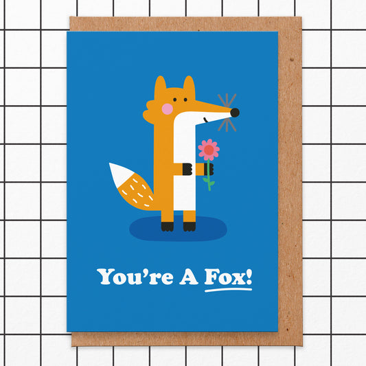Love card that reads you're a fox! There's an illustration of a fox holding a flower.