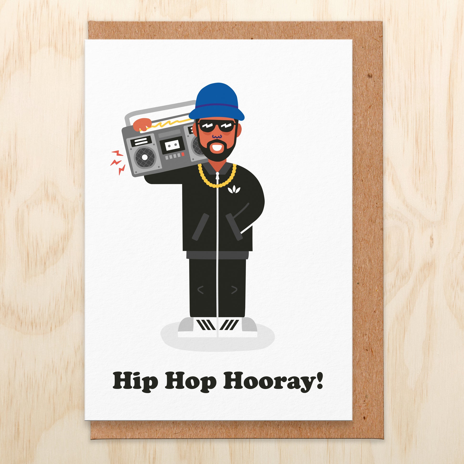 Birthday card that says hip hop hooray with an illustration of a man wearing sunglasses holding a boombox on his shoulder
