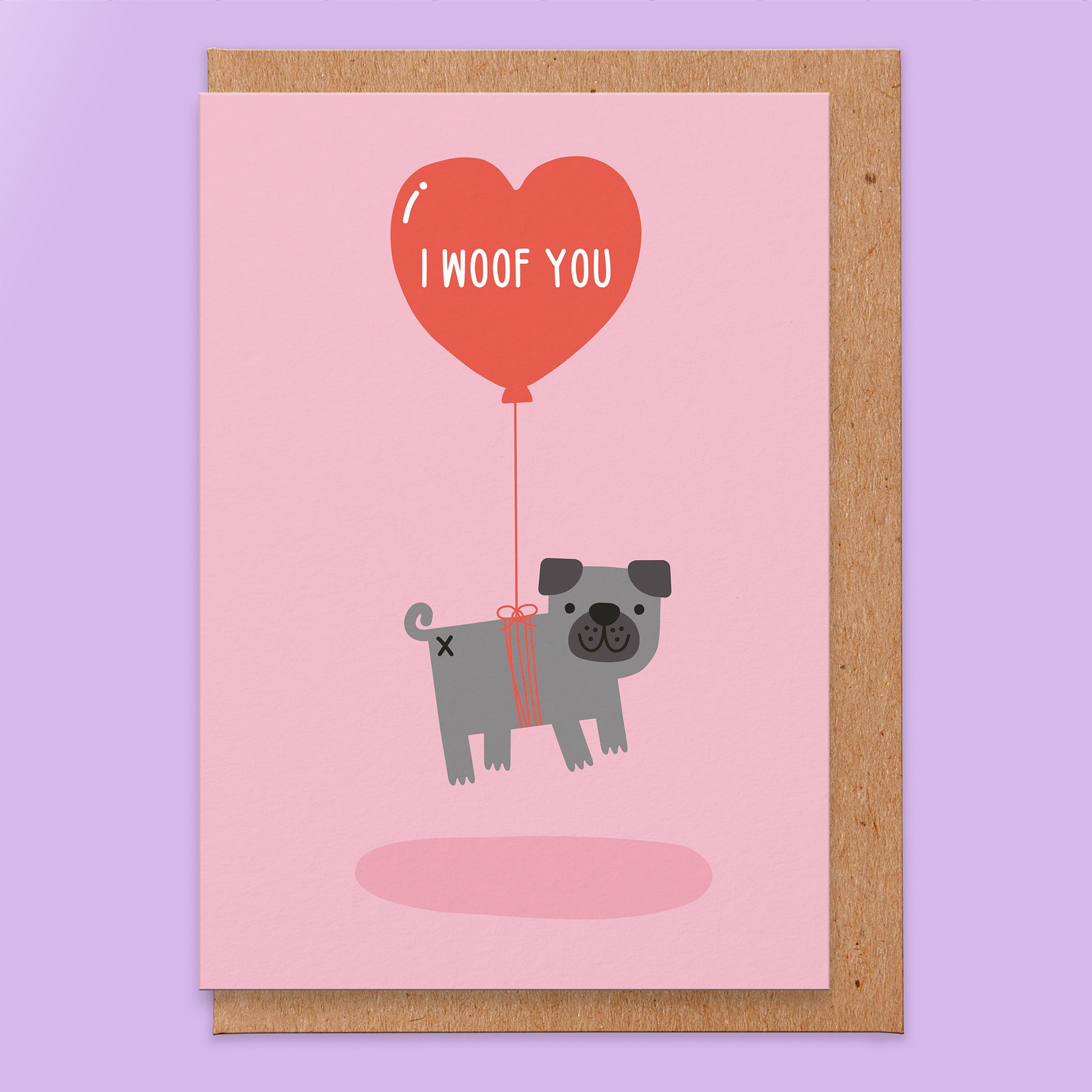 Love card that has a pink background and an illustration of a grey pug being lifted by a balloon in a heart shape that has I woof you in it.