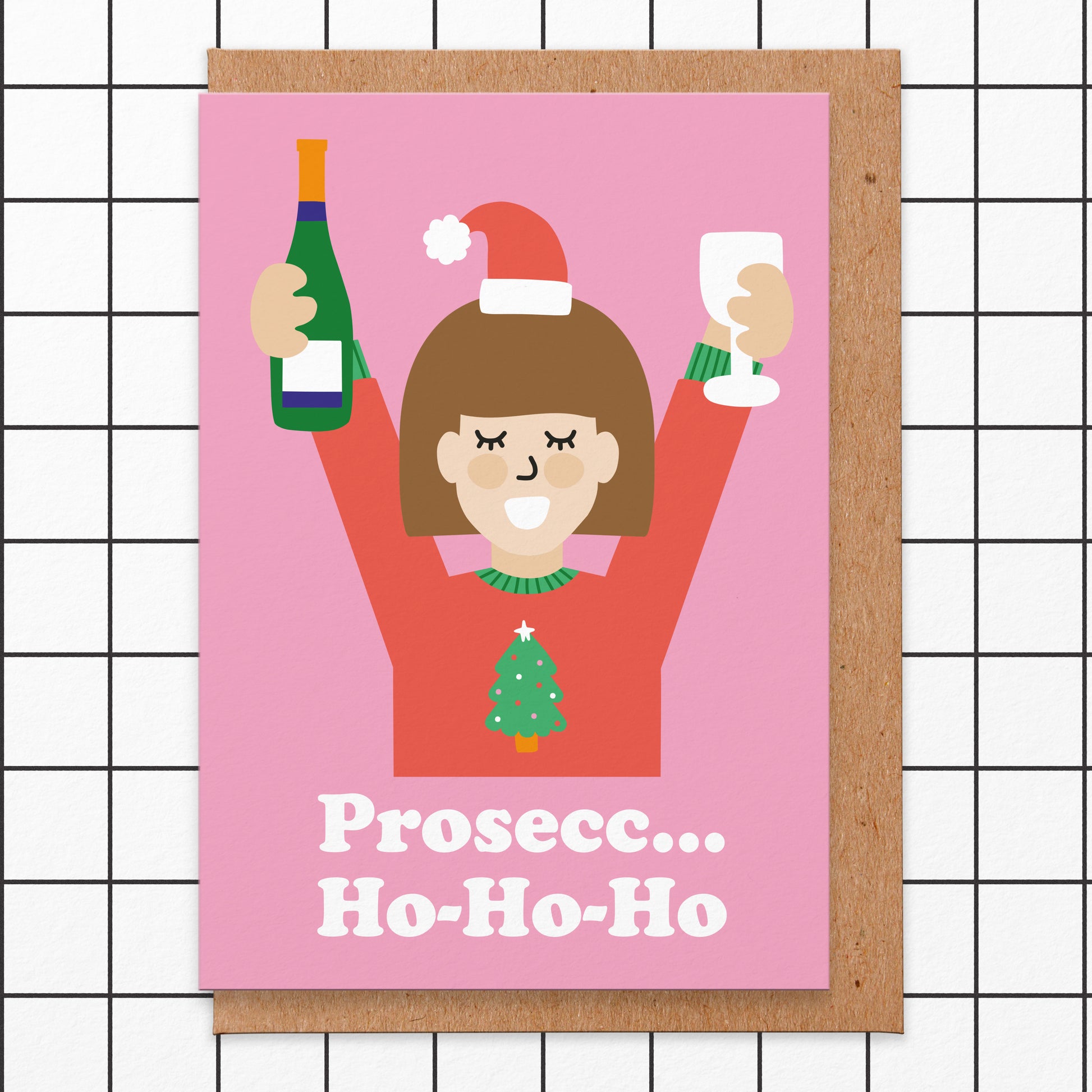 Christmas card with an illustration of a lady wearing a christmas jumper holding her arms up in the air with a bottle of Prosecco in one hand and a glass in the other. The card reads prosecc... ho-ho-ho.