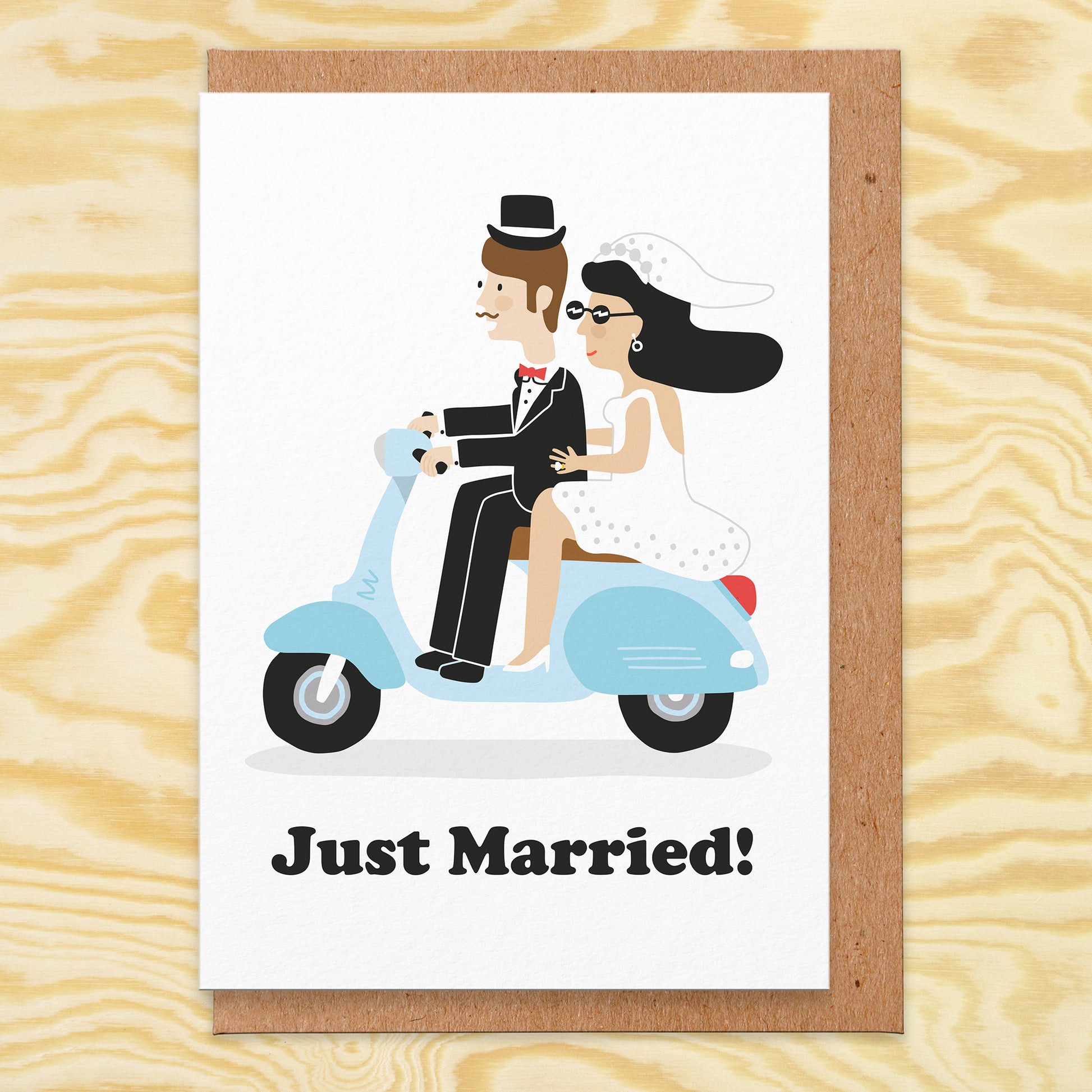 Wedding card that reads just married. There's an illustration of a retro scooter and a bride and groom riding it.