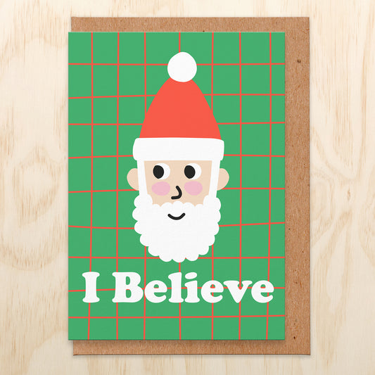 Christmas card with an illustration of Santa and it reads I believe.