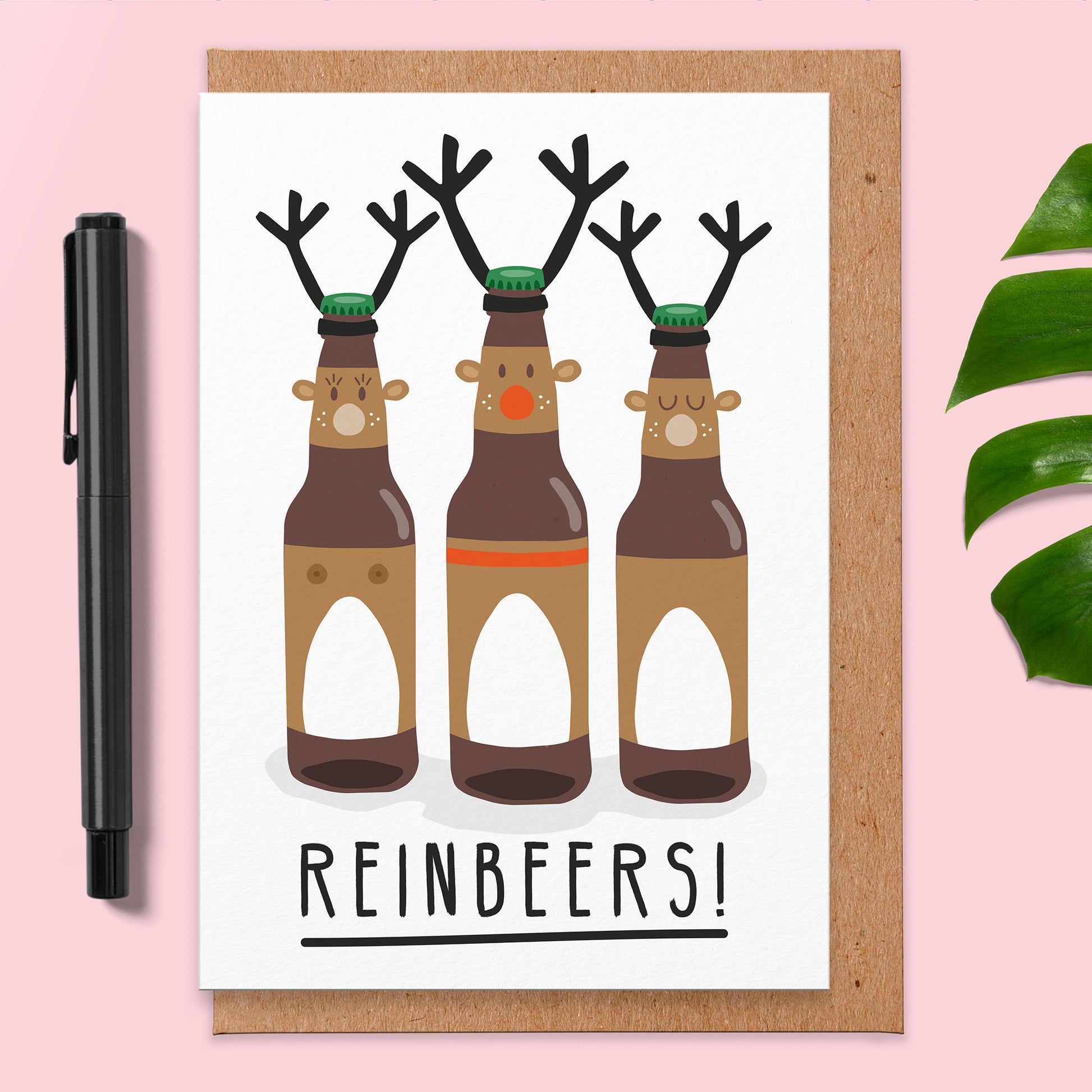 Christmas card with an illustration of 3 bottles of beer that have antlers and ears and the middle one has a red nose. The card reads reinbeers!