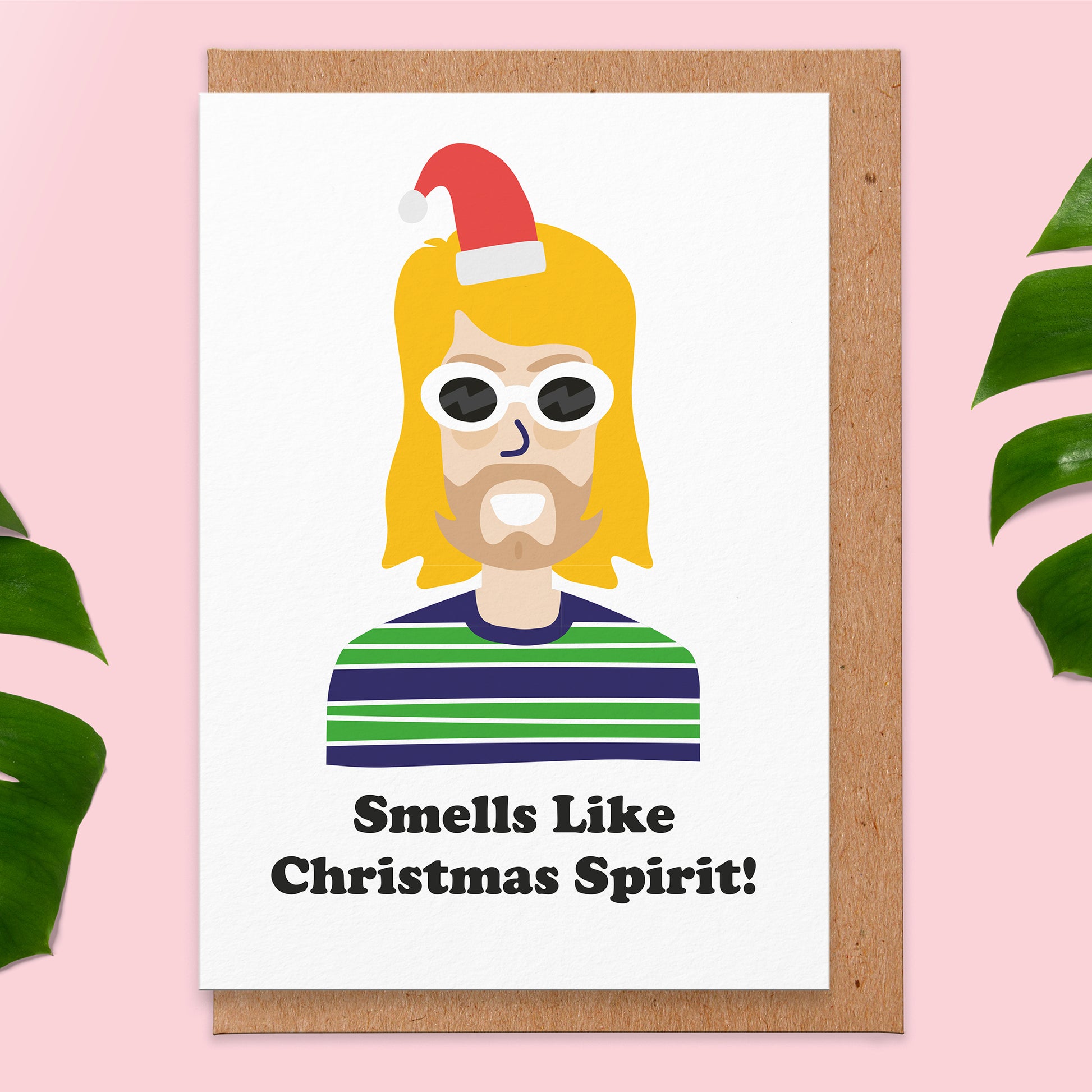 Greetings card that says smells like Christmas spirit on and an illustration of grunge icon wearing a Christmas hat.