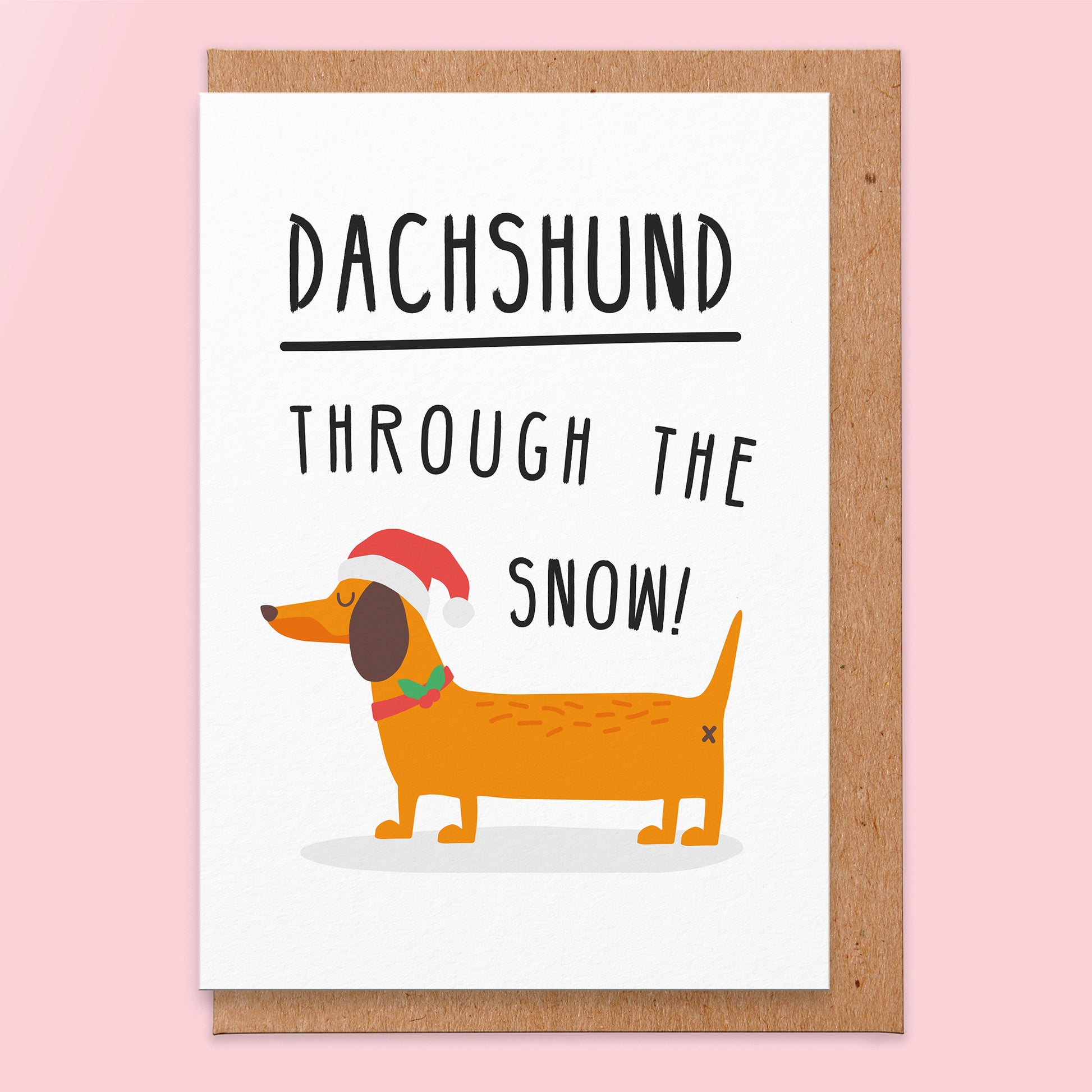 Christmas greeting card that has an illustration of a  Dachshund in a Santa hat and says Dachshund Through The Snow!